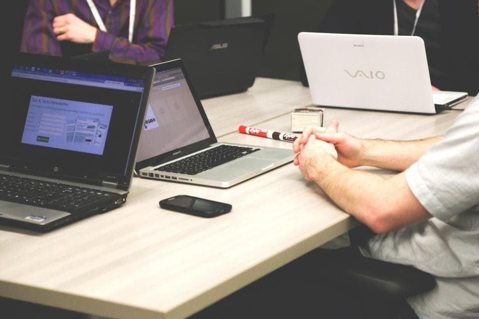 A team working on laptops around a table